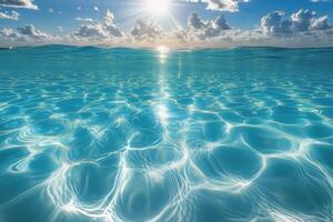 Serene turquoise ocean under bright sun reflects clouds and waves at midday by the coast photo
