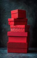 A stack of beautifully designed red gift boxes with intricate patterns in a cozy setting photo
