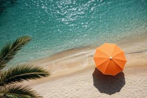 Relaxing beach view with an orange umbrella near clear turquoise waters in a tropical paradise photo