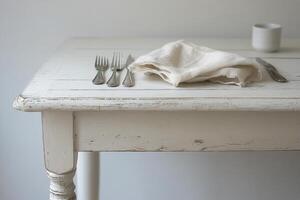 Elegant dining setup featuring silver forks and a textured linen napkin on a wooden table photo