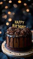 A beautifully crafted chocolate cake with smooth frosting and golden decoration stands prominently photo