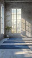 Bright and serene yoga studio with blue mats and large windows during sunrise photo