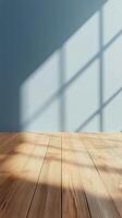 Soft shadows cast over a light blue wall and wooden floor during daytime in a peaceful space photo