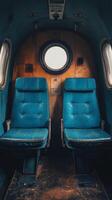 Empty train seats with blue upholstery beside a window during daylight hours photo