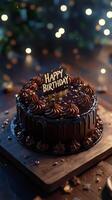 A beautifully crafted chocolate cake with smooth frosting and golden decoration stands prominently photo