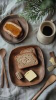 Breakfast setup with whole grain bread, butter, honey, and coffee on a linen tablecloth photo