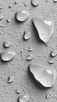 Water droplets on a textured surface creating a shimmering effect in soft light photo