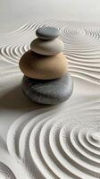 Stacked stones on rippled sand create a calm and balanced landscape in a tranquil setting photo