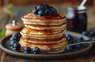 Stack of Buttery Pancakes With Blueberries and Syrup for Breakfast photo