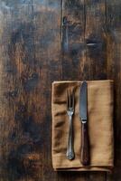 un rústico de madera mesa conjunto con cubiertos y lino servilleta en un acogedor comida zona a hora de comer foto