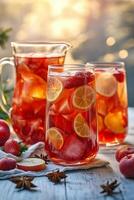 Refreshing summer fruit tea served in a pitcher with fresh fruit ingredients on a table photo