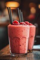 Refreshing raspberry smoothies garnished with mint leaves served on a rustic wooden table photo