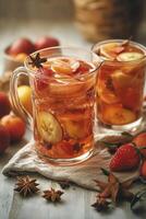 Refreshing summer fruit tea served in a pitcher with fresh fruit ingredients on a table photo