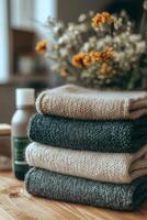 Colorful stack of hand knit sweaters displayed in a cozy workshop setting during autumn photo