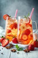Refreshing summer fruit tea served in a pitcher with fresh fruit ingredients on a table photo