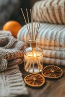 Warm cozy setting with diffuser, candle, and dried orange slices for relaxation photo