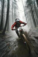 Mountain biker splashes through mud in a dense forest during a rainy day photo