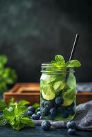Refreshing green smoothie with blueberries served in a jar on a rustic wooden tray photo