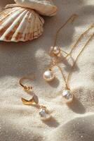 Elegant gold jewelry with pearls scattered on sandy beach near seashell at sunset photo
