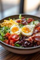 Fresh salad bowl with vegetables, bacon, and soft boiled eggs served in a restaurant photo