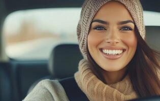 Smiling woman wearing a headscarf in a car with a bright background during daytime photo