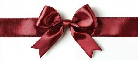 Elegant red ribbon bow placed on a plain background for decoration or gift wrapping photo