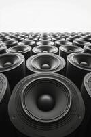 Collection of black speakers arranged in a geometric pattern on a neutral background photo