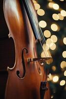 Beautiful wooden violin with soft bokeh lights in the background during a festive evening photo