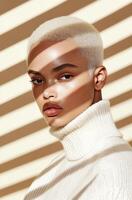Young man with light hair poses in shadows and light from window blinds photo
