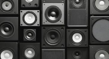 Array of black speakers showcasing different sizes and designs in a modern setting photo