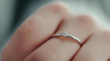 Engagement ring displayed on a hand with a blurred background during a romantic moment photo
