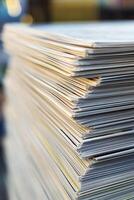 Close up view of stacked white paper sheets in an office workspace during daylight hours photo