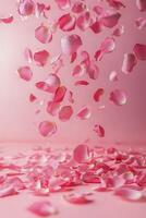 Petals scattered on a soft pink background create a serene and romantic atmosphere indoors photo