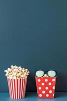 Colorful popcorn containers with playful designs on a blue background photo
