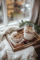 Delicious breakfast tray with granola, berries, and milk in a cozy setting photo