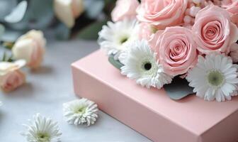 Beautiful floral arrangement in pink box highlighting roses, daisies, and other blooms photo