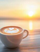 Coffee cup with latte art on a table during sunset at a cozy cafe photo