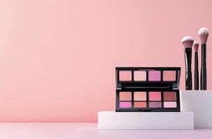 Colorful makeup palette and brushes arranged on a white platform with a soft pink background photo