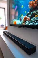 Modern living room with soundbar and aquarium view on television screen photo