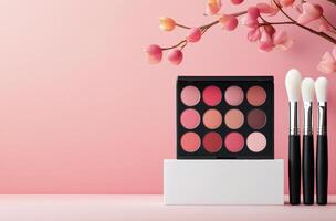 Colorful makeup palette and brushes arranged on a white platform with a soft pink background photo