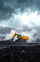 Heavy machinery operates in rugged terrain during cloudy weather photo