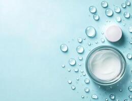 Soft cream with water droplets on a blue background for skincare products display photo
