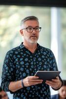 Professional presenting information during a business meeting at a modern office photo