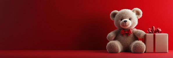 Soft bear beside a red gift box with a bow on a bright red background for festive occasions photo