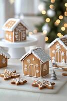 Gingerbread house decorations and star cookies displayed in a cozy holiday setting photo