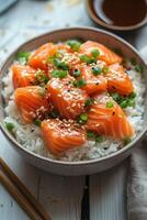 Delicious salmon sashimi served over jasmine rice with green onions and sesame seeds photo