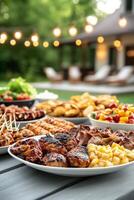 Outdoor summer barbecue party with grilled meats and fresh sides under string lights photo
