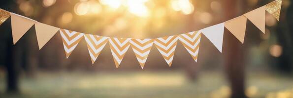 Colorful decorative bunting hanging in a sunlit park during a warm afternoon gathering photo