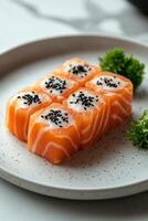 Delicious salmon cubes arranged beautifully on a decorative plate with specks and garnish photo