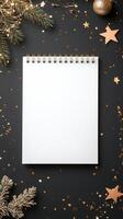 Elegant flat lay of a blank notebook surrounded by festive decorations on a dark background photo